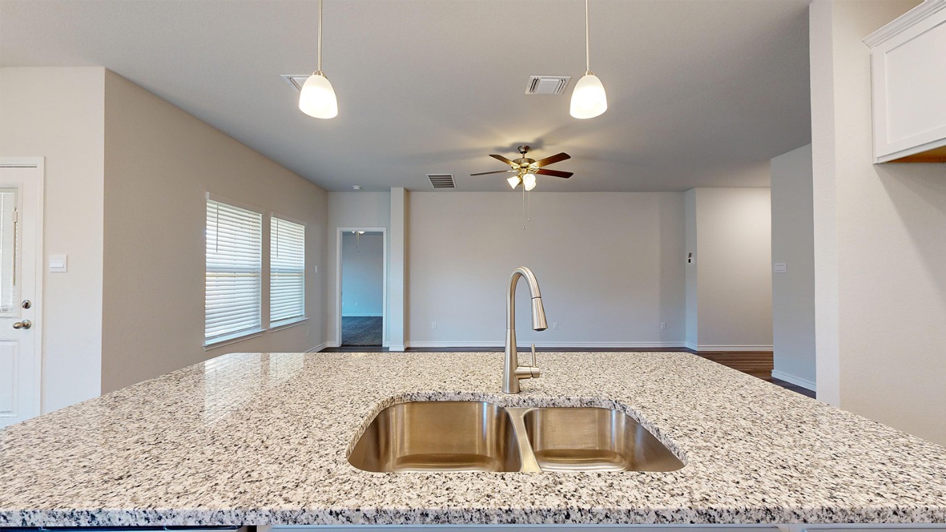 305 Creekfall Road Burnet, TX 78611 - Photo 29 of 33 a kitchen with a sink granite counter tops and a window
