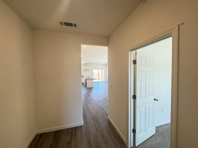 a view of hallway with wooden floor
