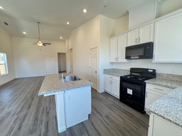 a kitchen with a sink stove and refrigerator