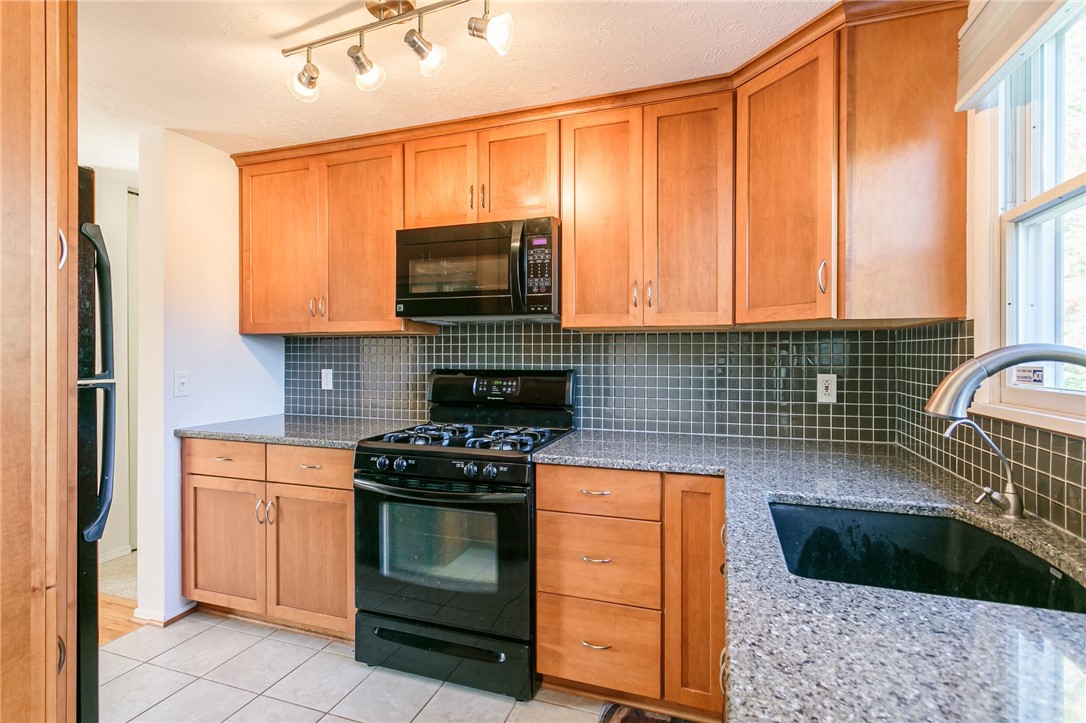 14 Prairie Trail Henrietta, NY 14586 - Photo 5 of 20 Granite countertops with wood cabinets and modern