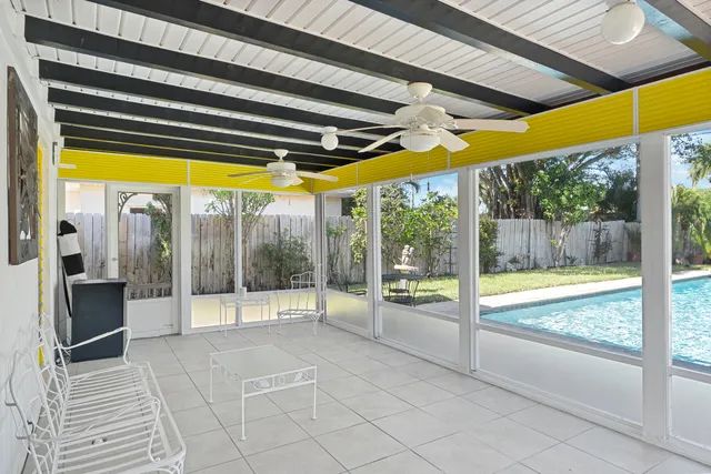 a view of swimming pool with table and chairs under an umbrella