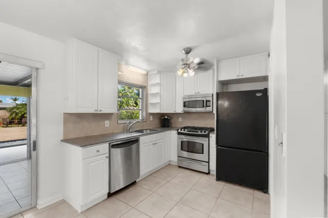 a kitchen with a sink stainless steel appliances and cabinets