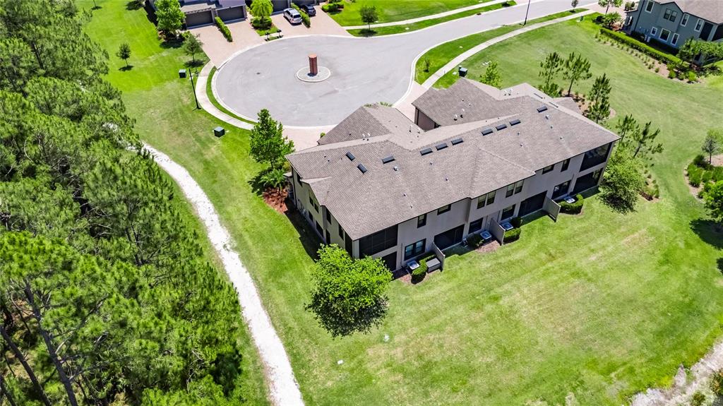 4899 Isola Court Wesley Chapel, FL 33543 - Photo 13 of 86 an aerial view of a house with a garden