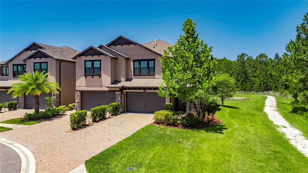 4899 Isola Court Wesley Chapel, FL 33543 - Photo 18 of 86 a front view of a house with a yard
