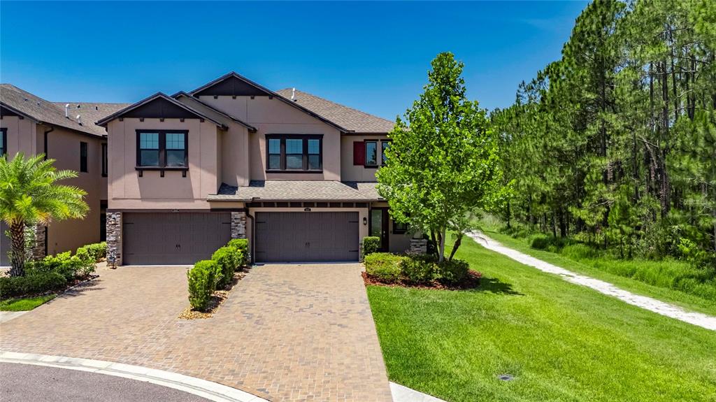 4899 Isola Court Wesley Chapel, FL 33543 - Photo 2 of 86 a front view of a house with a garden