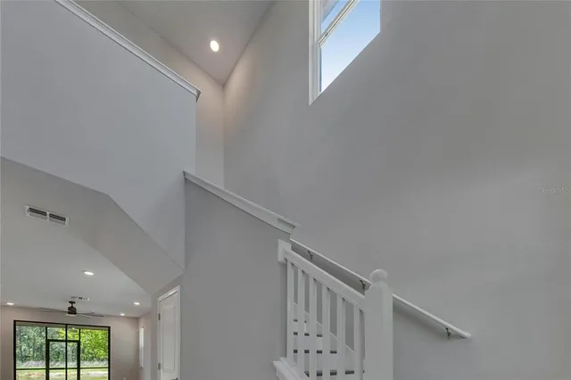 an aerial view of a house with a yard and wooden fence