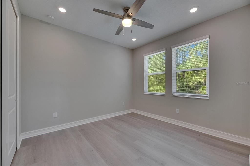 4899 Isola Court Wesley Chapel, FL 33543 - Photo 53 of 86 an empty room with wooden floor and windows