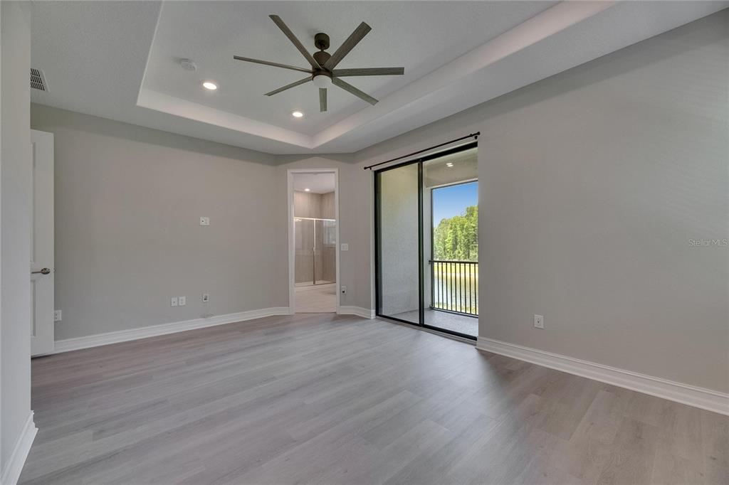 4899 Isola Court Wesley Chapel, FL 33543 - Photo 58 of 86 an empty room with wooden floor and windows