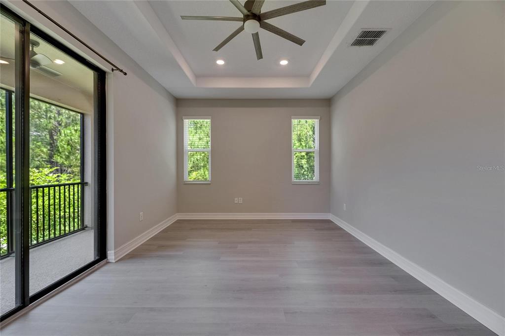 4899 Isola Court Wesley Chapel, FL 33543 - Photo 62 of 86 an empty room that has a window and a ceiling fan