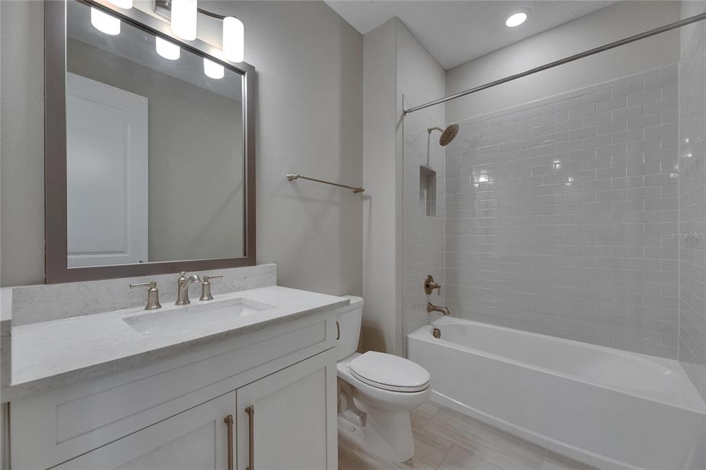 4899 Isola Court Wesley Chapel, FL 33543 - Photo 68 of 86 a bathroom with a sink a toilet and shower