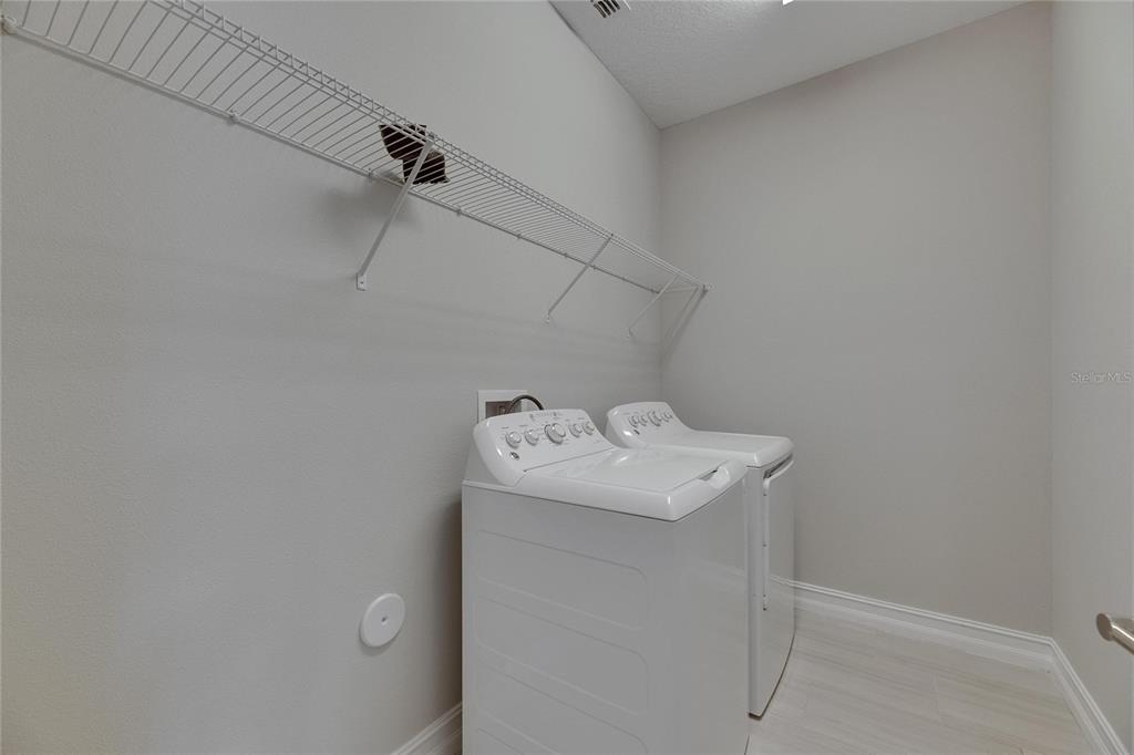 4899 Isola Court Wesley Chapel, FL 33543 - Photo 70 of 86 a utility room with dryer and washer