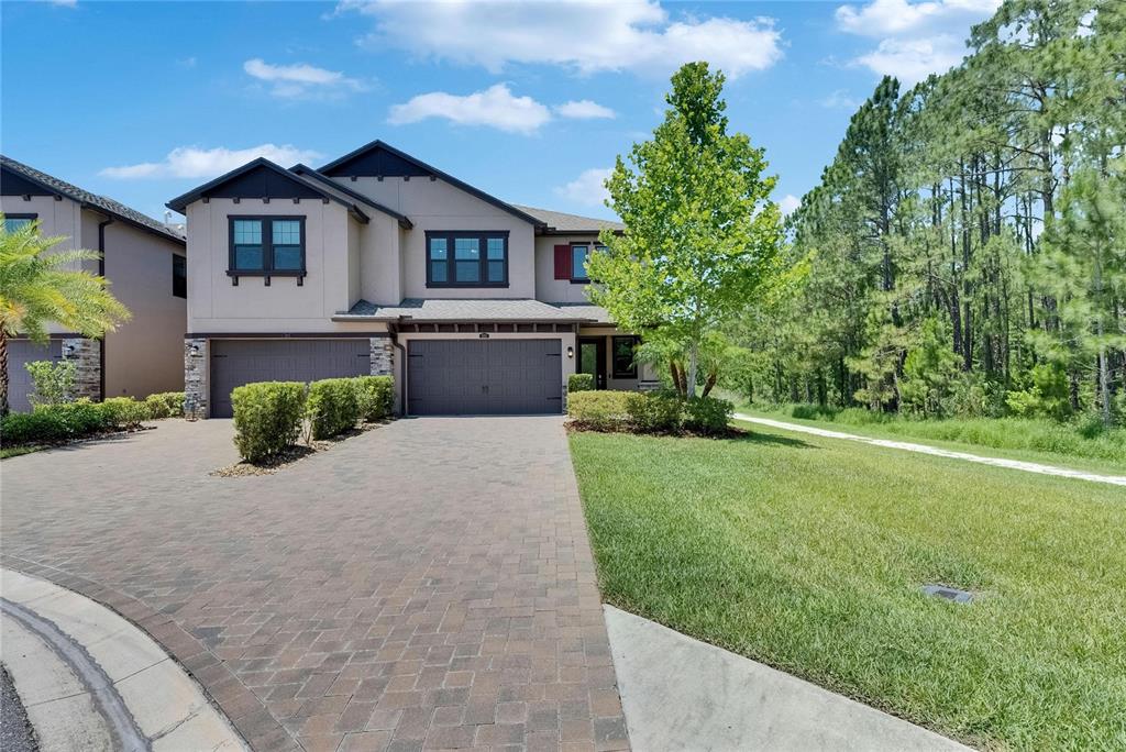 4899 Isola Court Wesley Chapel, FL 33543 - Photo 73 of 86 a front view of a house with a yard