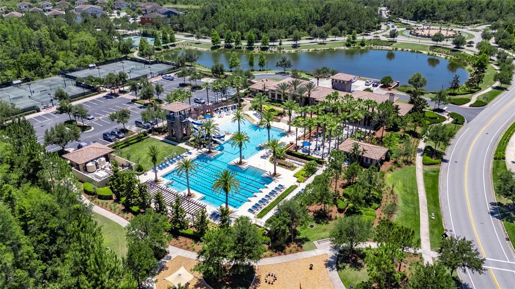 4899 Isola Court Wesley Chapel, FL 33543 - Photo 77 of 86 an aerial view of a houses with a lake view