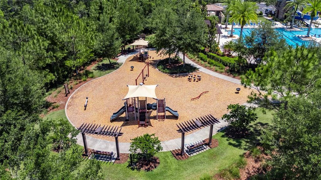 4899 Isola Court Wesley Chapel, FL 33543 - Photo 79 of 86 an aerial view of a house with outdoor space and trees all around