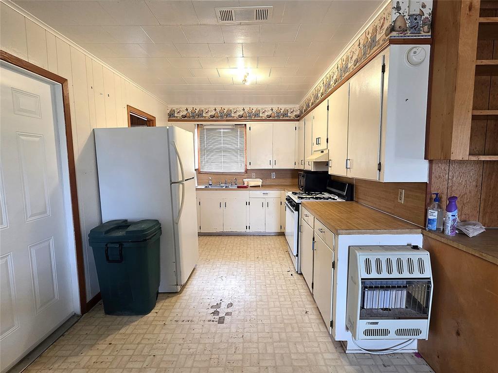 3049 Highway 507 Coushatta, LA 71019 - Photo 12 of 39 a kitchen with a refrigerator a stove a sink dishwasher and wooden cabinets