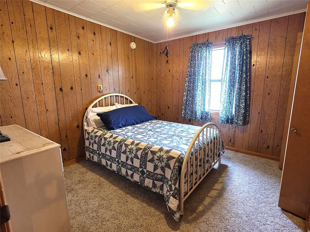 3049 Highway 507 Coushatta, LA 71019 - Photo 15 of 39 a bedroom with a bed and a chandelier