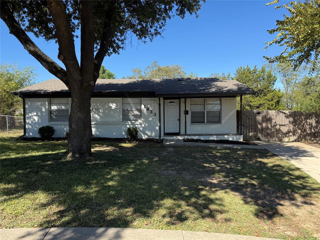 View of front of home with brick siding and roof with shingles