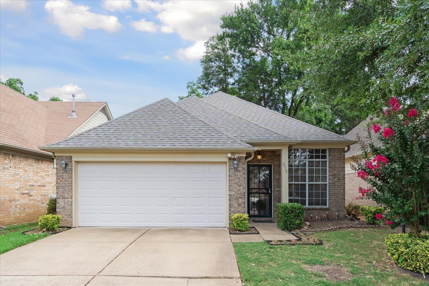 6948 Wynne Ridge Road North Cordova, TN 38016 - Photo 1 of 13 a front view of a house with garden