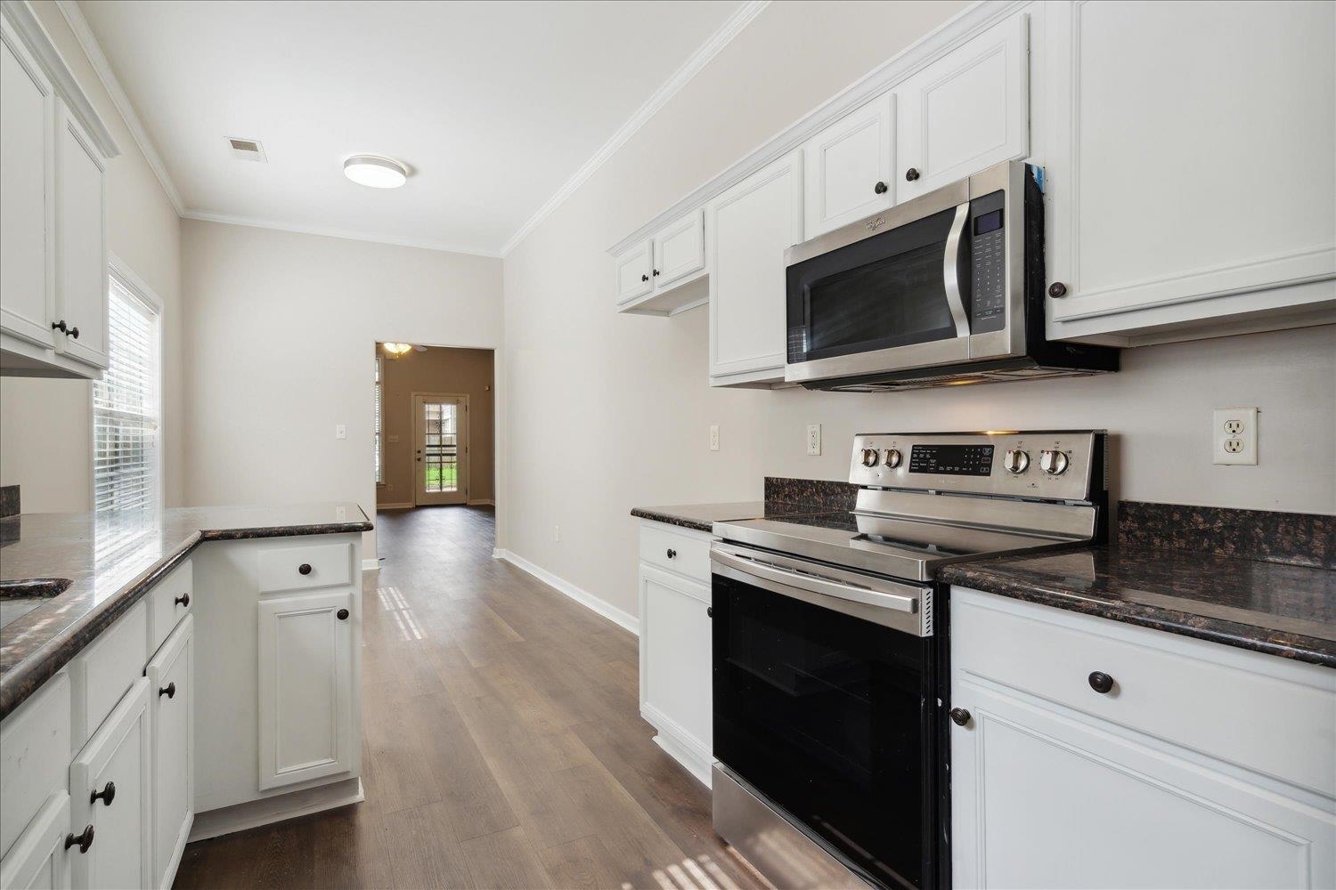 6948 Wynne Ridge Road North Cordova, TN 38016 - Photo 6 of 13 a kitchen with stainless steel appliances white cabinets and a stove