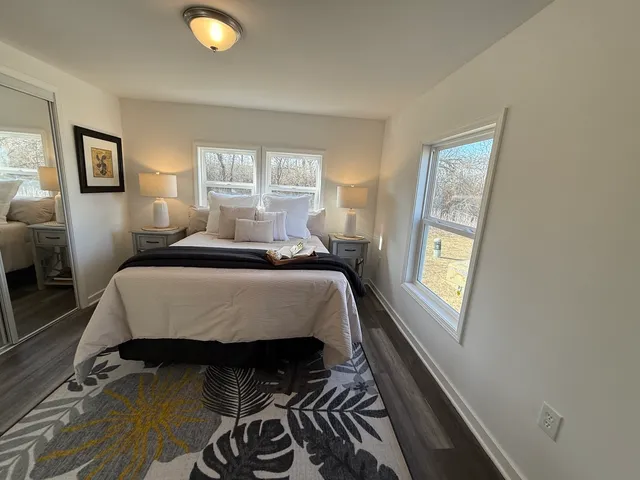 a bedroom with a bed and a window