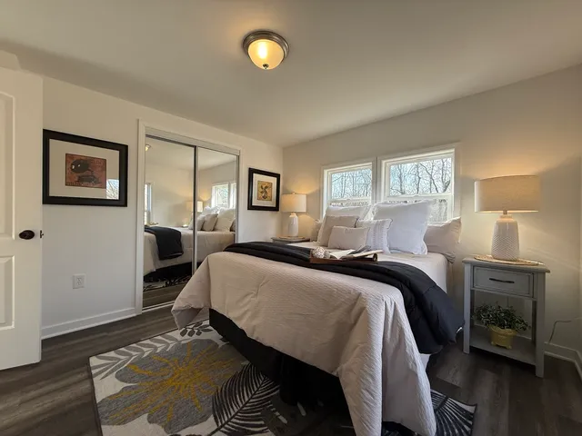 a bedroom with a bed and wooden floor