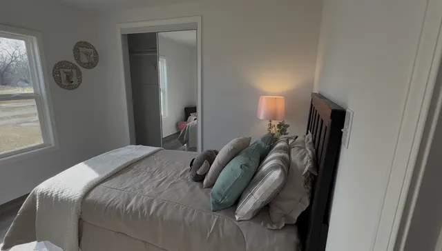 a bedroom with a bed and a window