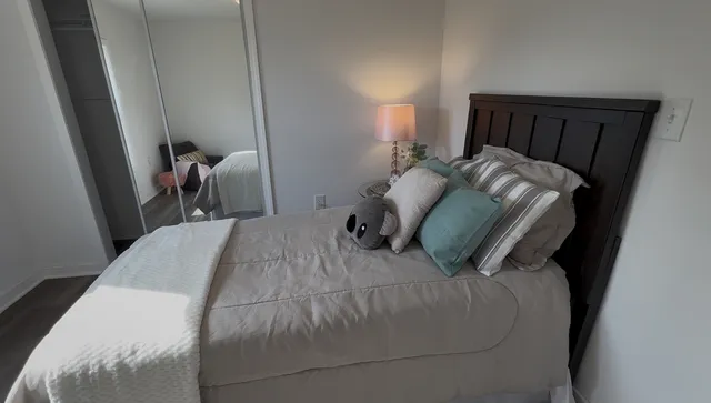 a bed sitting in a bedroom next to a window