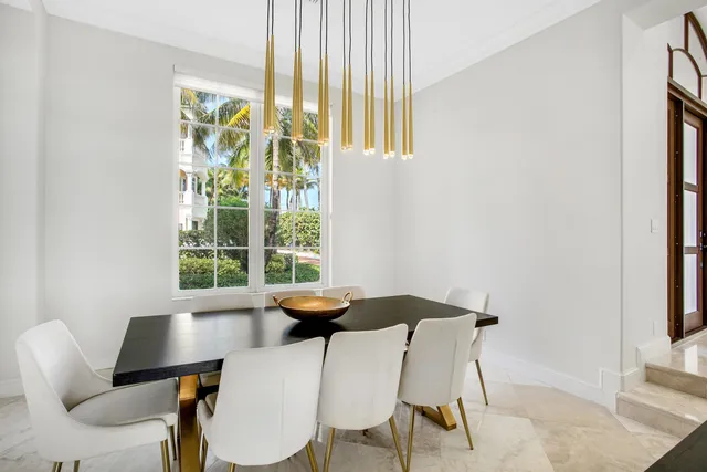 a view of a dining room with furniture and a window