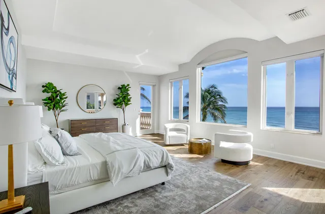 a living room with a couch and a potted plant