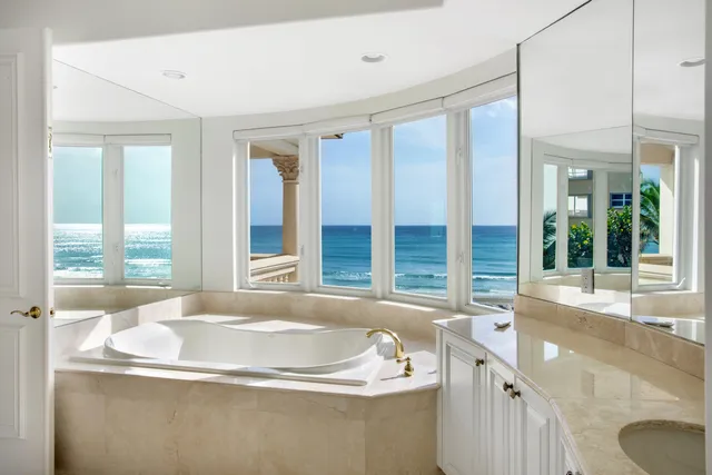 a bath tub sitting in a bathroom next to a window