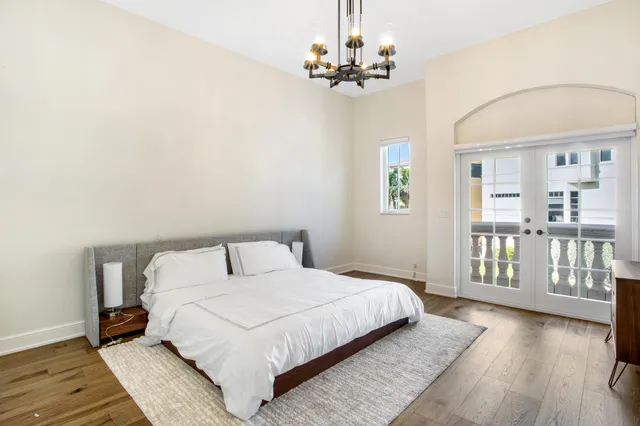 a bedroom with a large bed and a wooden floor