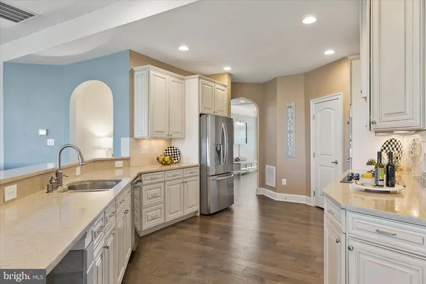 a large kitchen with a sink dishwasher a refrigerator and a sink