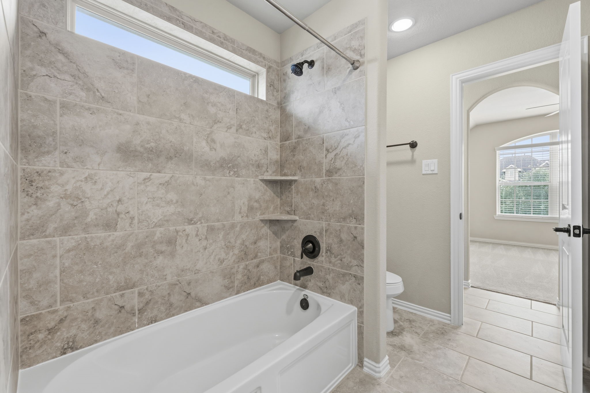 25210 Gaddis Oaks Drive Spring, TX 77389 - Photo 32 of 50 a bathroom with a bathtub and a shower