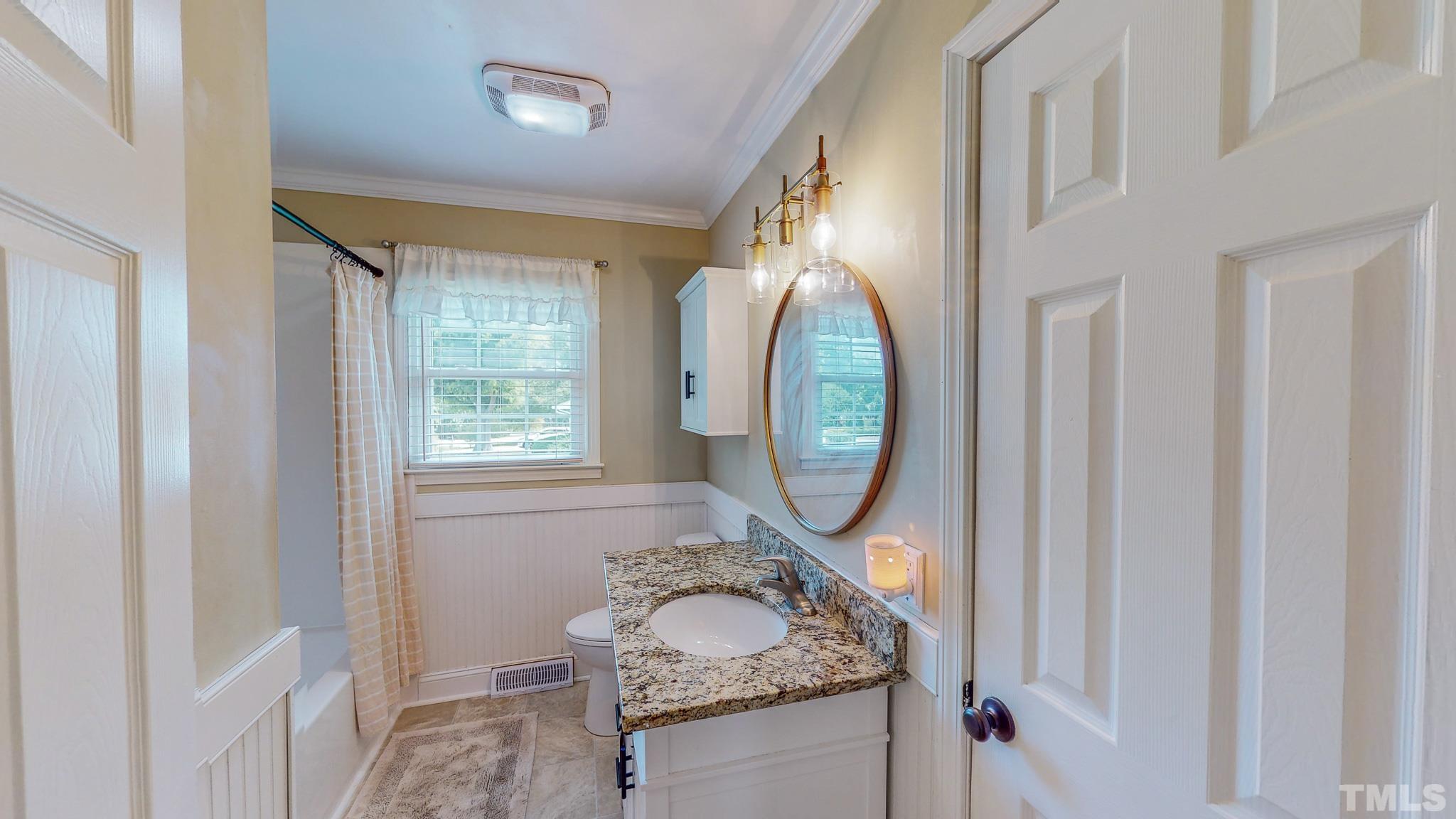 650 Younger Roxboro, NC 27573 - Photo 21 of 42 a bathroom with a granite countertop toilet sink and mirror