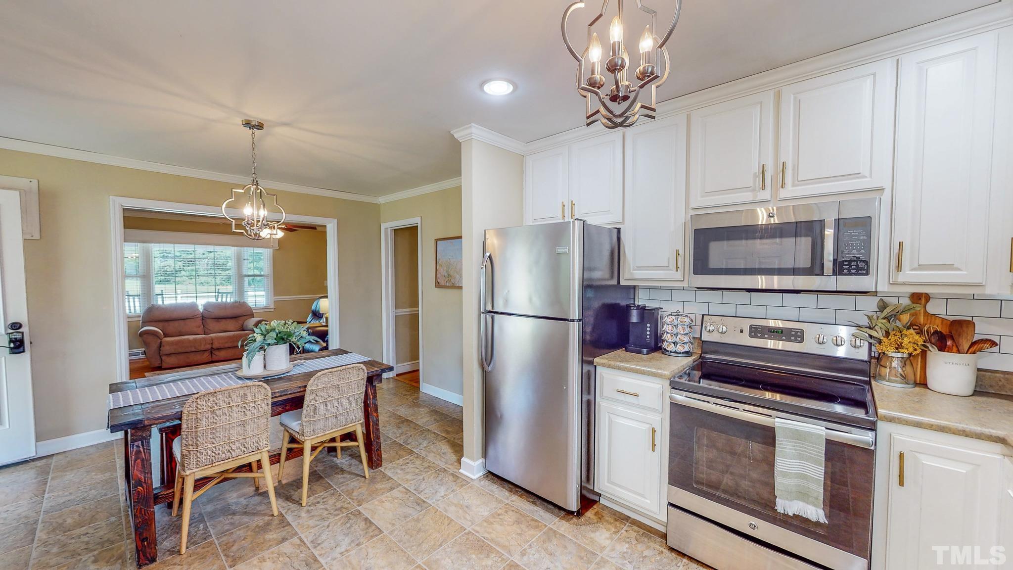 650 Younger Roxboro, NC 27573 - Photo 5 of 42 a kitchen with stainless steel appliances a stove refrigerator and cabinets
