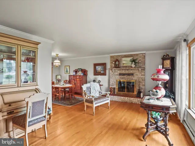 a dining room with furniture a chandelier and wooden floor