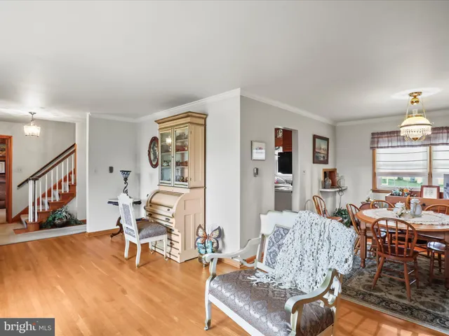 a dining room with furniture a rug and wooden floor