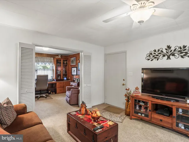 a living room with furniture a dining table and chairs with wooden floor