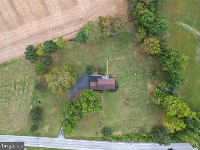 an aerial view of residential houses with outdoor space and river