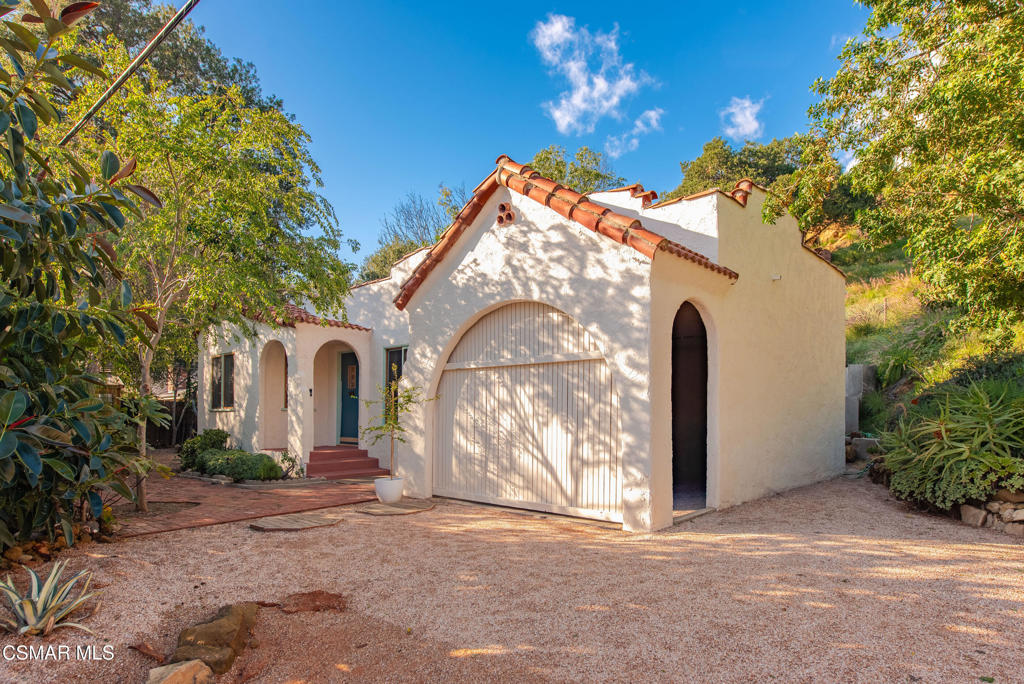 a front view of a house with plants