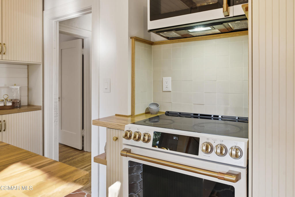 9160 Huston Road Chatsworth, CA 91311 - Photo 18 of 32 a view of a kitchen with a stove and a refrigerator