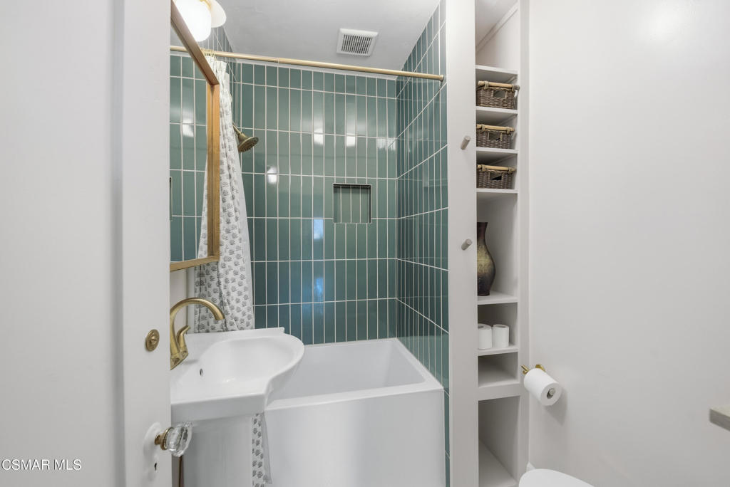 9160 Huston Road Chatsworth, CA 91311 - Photo 22 of 32 a bathroom with a shower toilet and sink