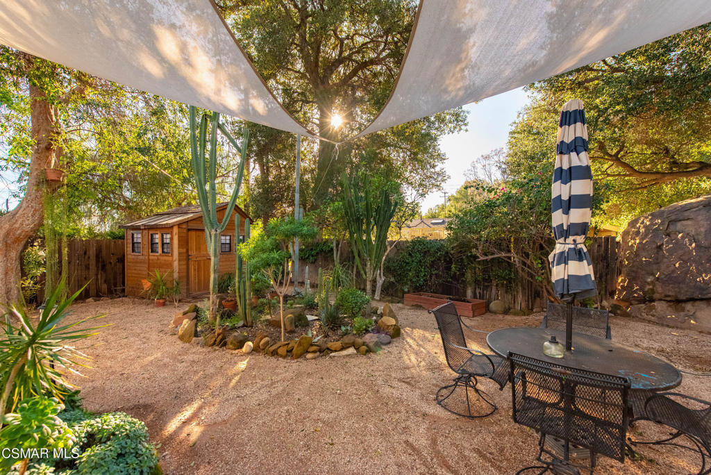 9160 Huston Road Chatsworth, CA 91311 - Photo 29 of 32 a view of a backyard with table and chairs and potted plants