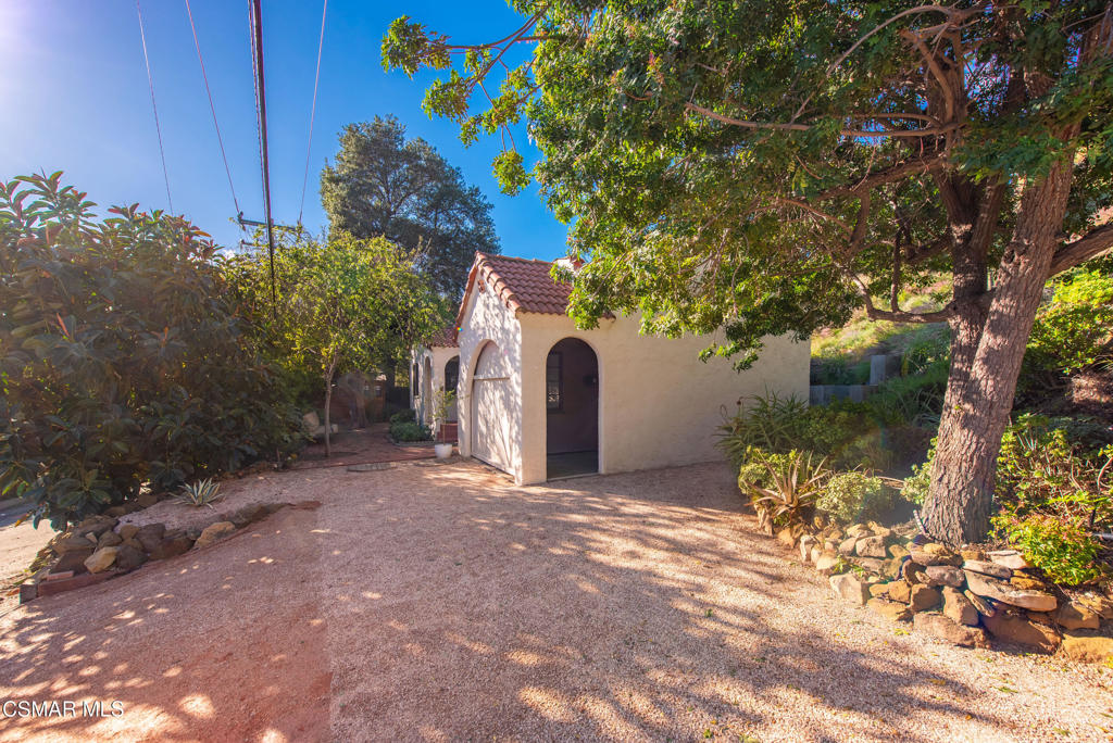 9160 Huston Road Chatsworth, CA 91311 - Photo 32 of 32 a front view of a house with a yard and garage