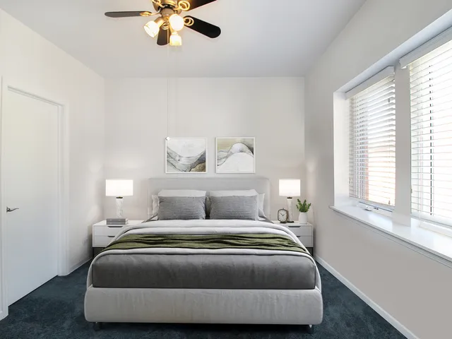 a bedroom with a bed and window