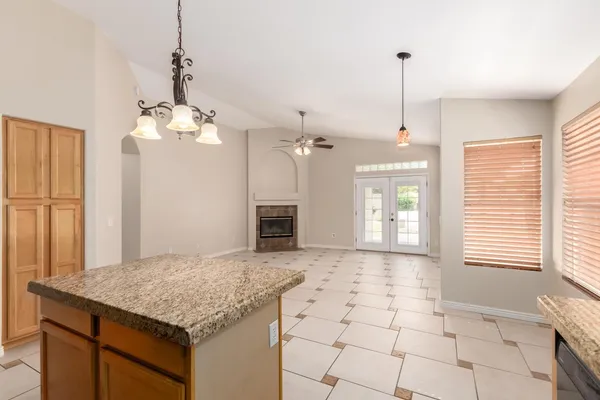 a kitchen with stainless steel appliances granite countertop a sink a counter space and a window