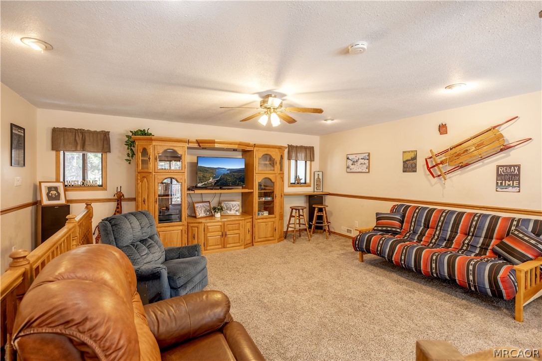 42324 Paramount Road Big Bear Lake, CA 92315 - Photo 31 of 50 a living room with furniture and a chandelier