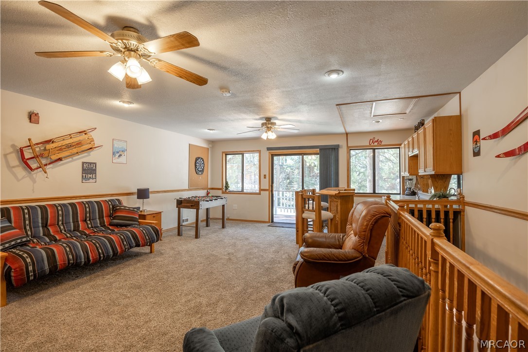 42324 Paramount Road Big Bear Lake, CA 92315 - Photo 32 of 50 a living room with furniture ceiling fan and a rug