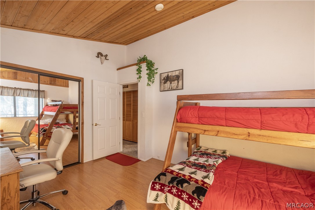 42324 Paramount Road Big Bear Lake, CA 92315 - Photo 36 of 50 a bedroom with a bed and wooden floor