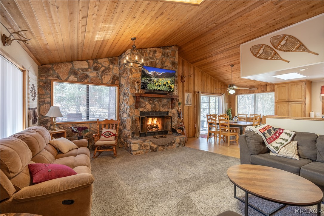 42324 Paramount Road Big Bear Lake, CA 92315 - Photo 4 of 50 a living room with furniture a fireplace and a large window